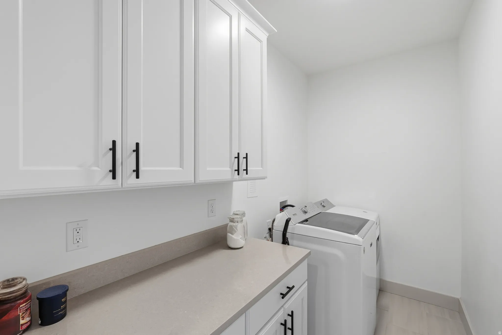 Laundry area featuring cabinet space and washing machine and clothes dryer