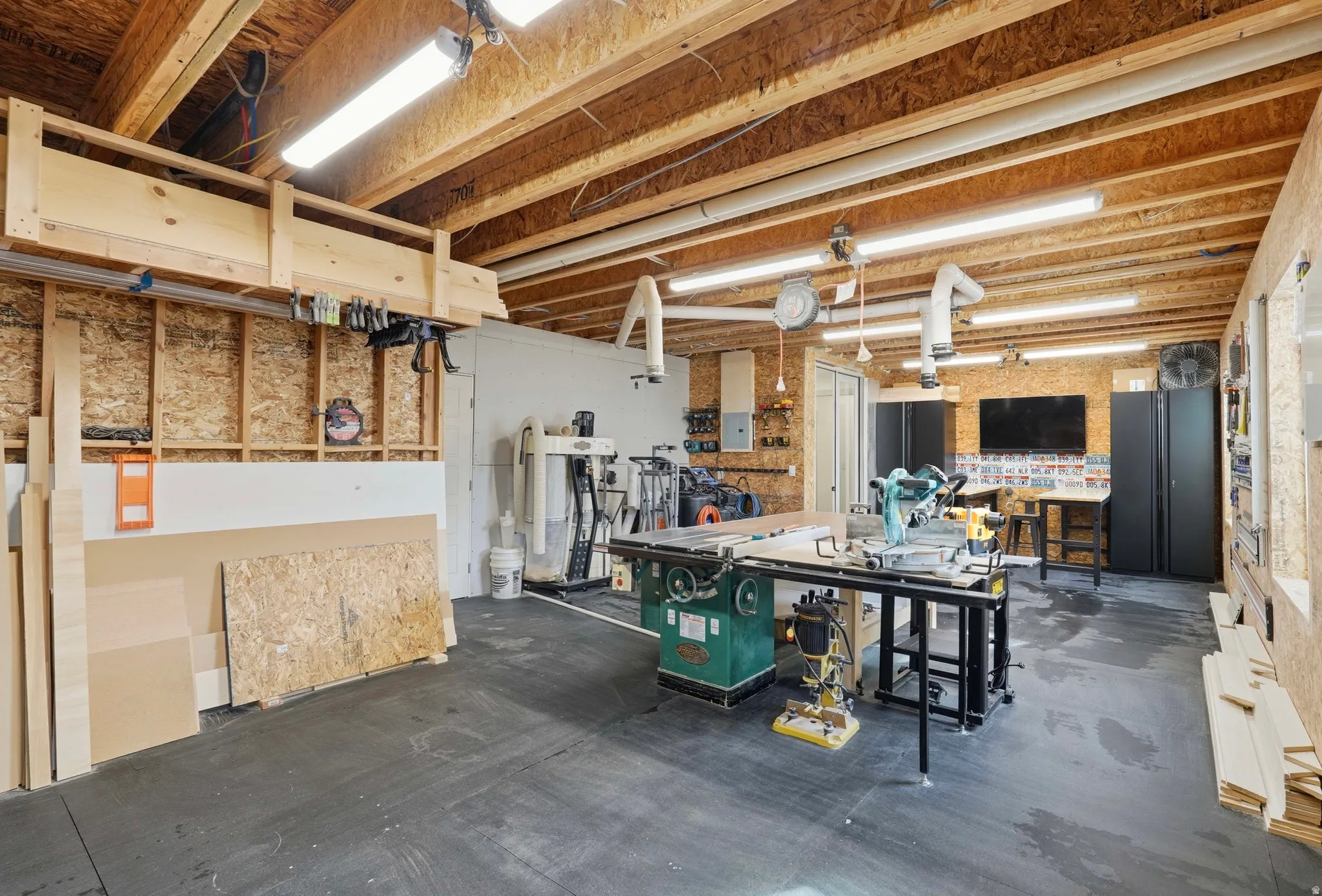 Miscellaneous room featuring a workshop area and concrete floors