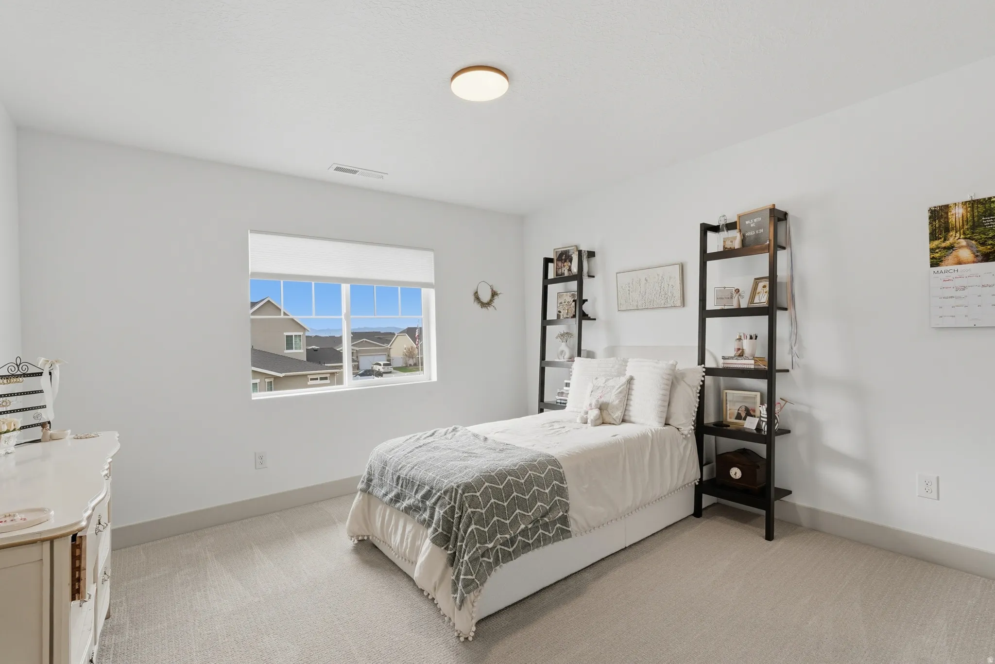 Bedroom featuring light colored carpet