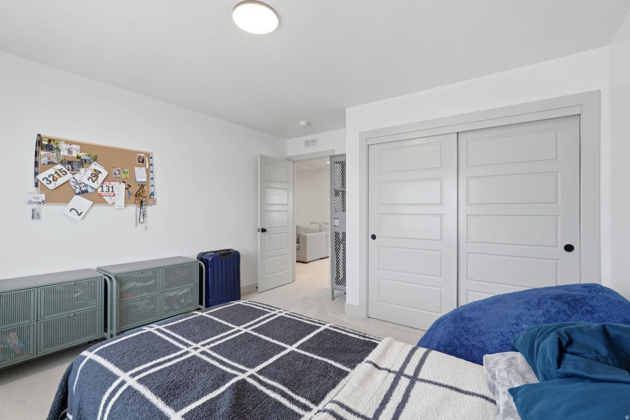 Bedroom with a closet and light carpet