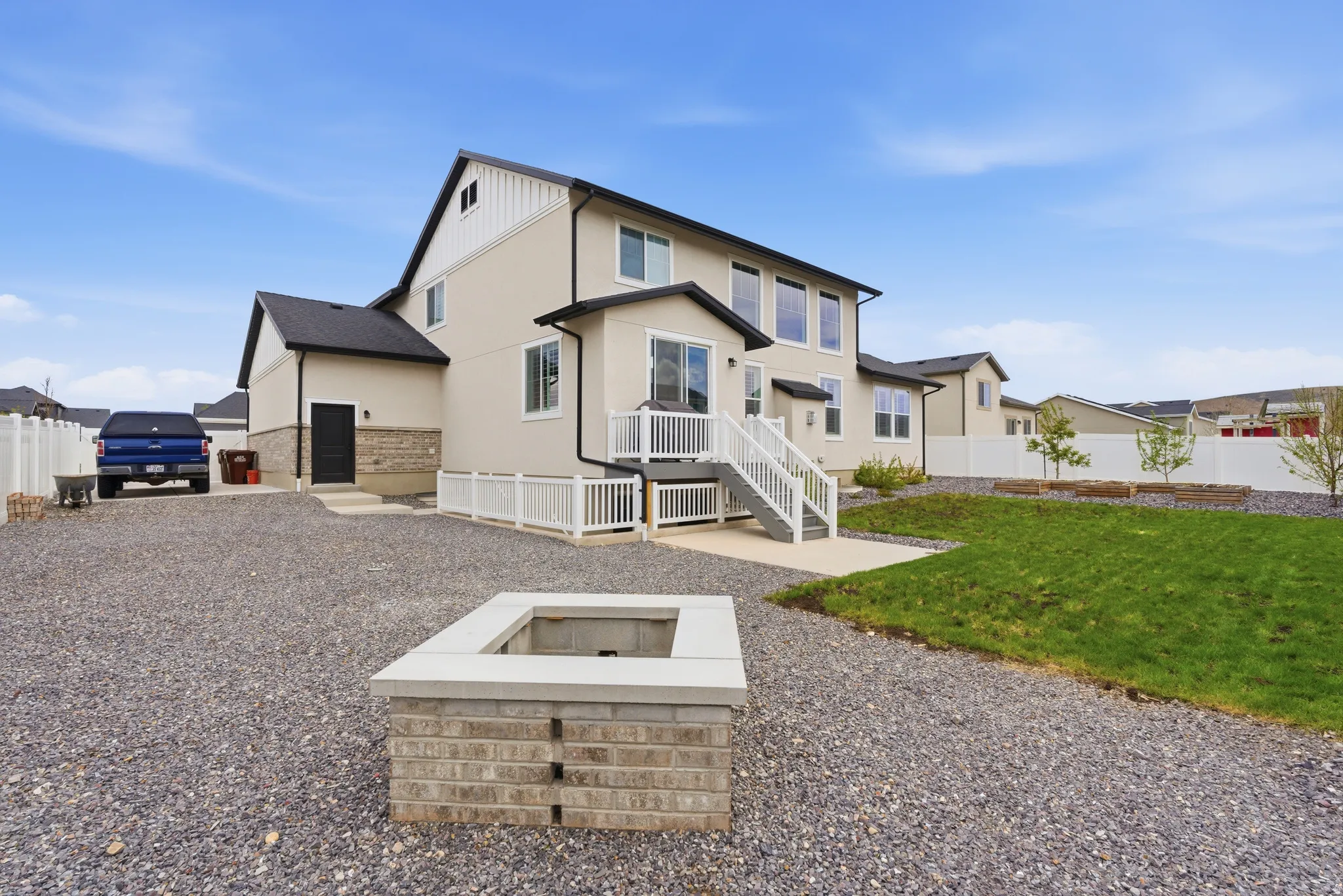 Back of house featuring an outdoor fire pit, a fenced backyard, a patio, and stucco siding