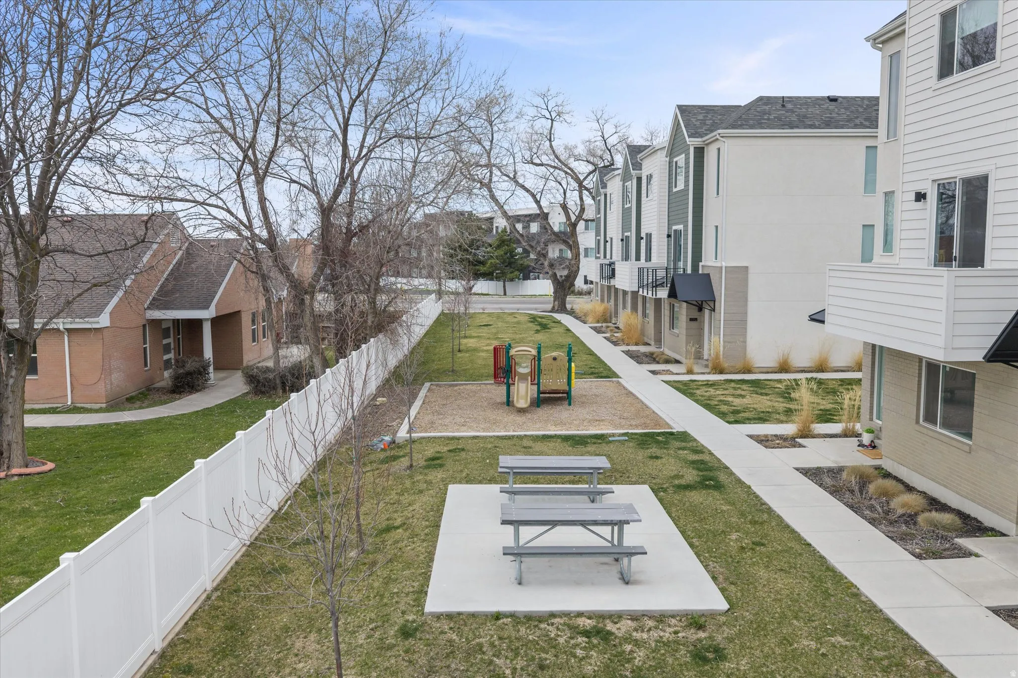 View of yard with picnic tables, TOT-LOT, and green space.