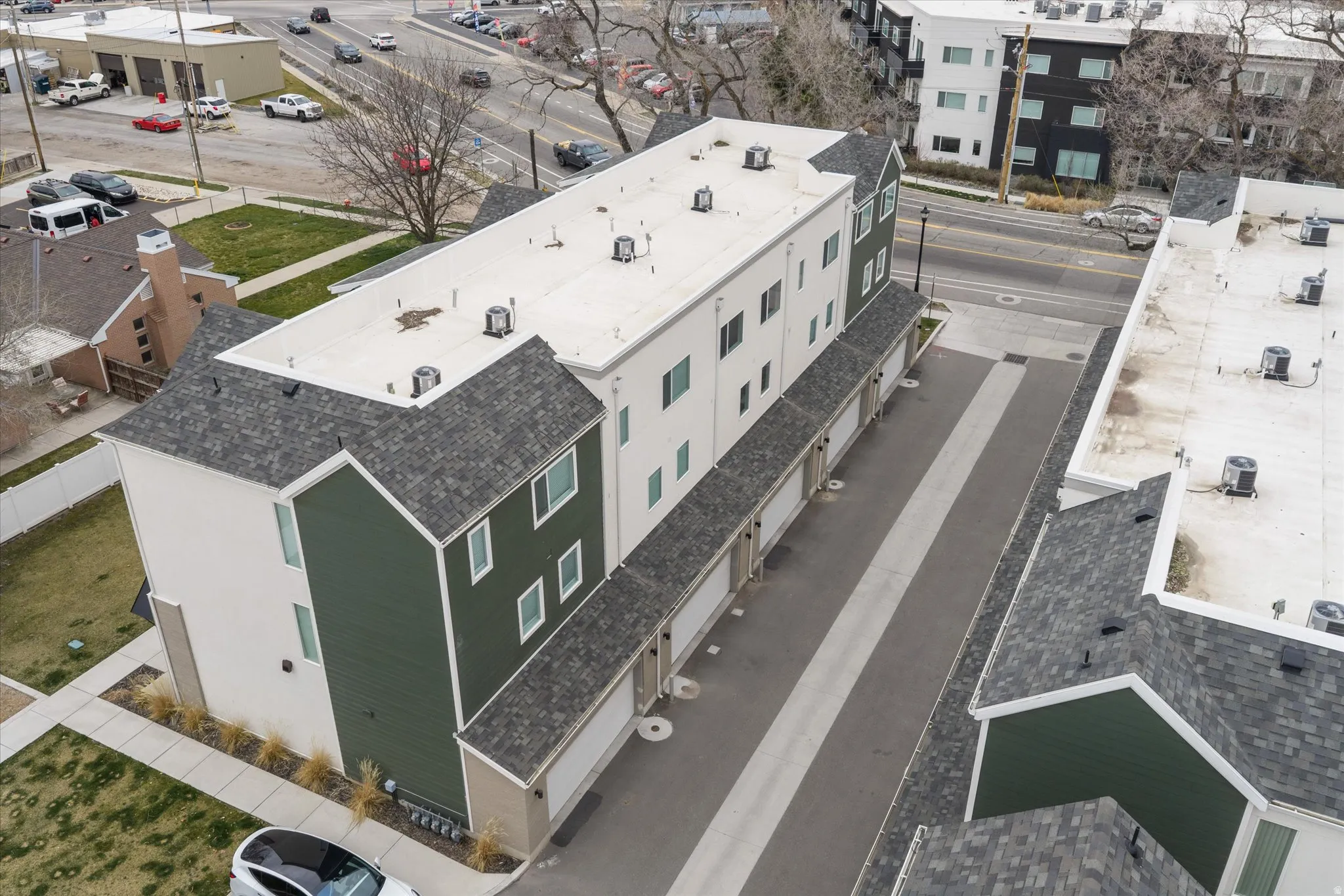 Bird's eye view of garage side of townhomes.