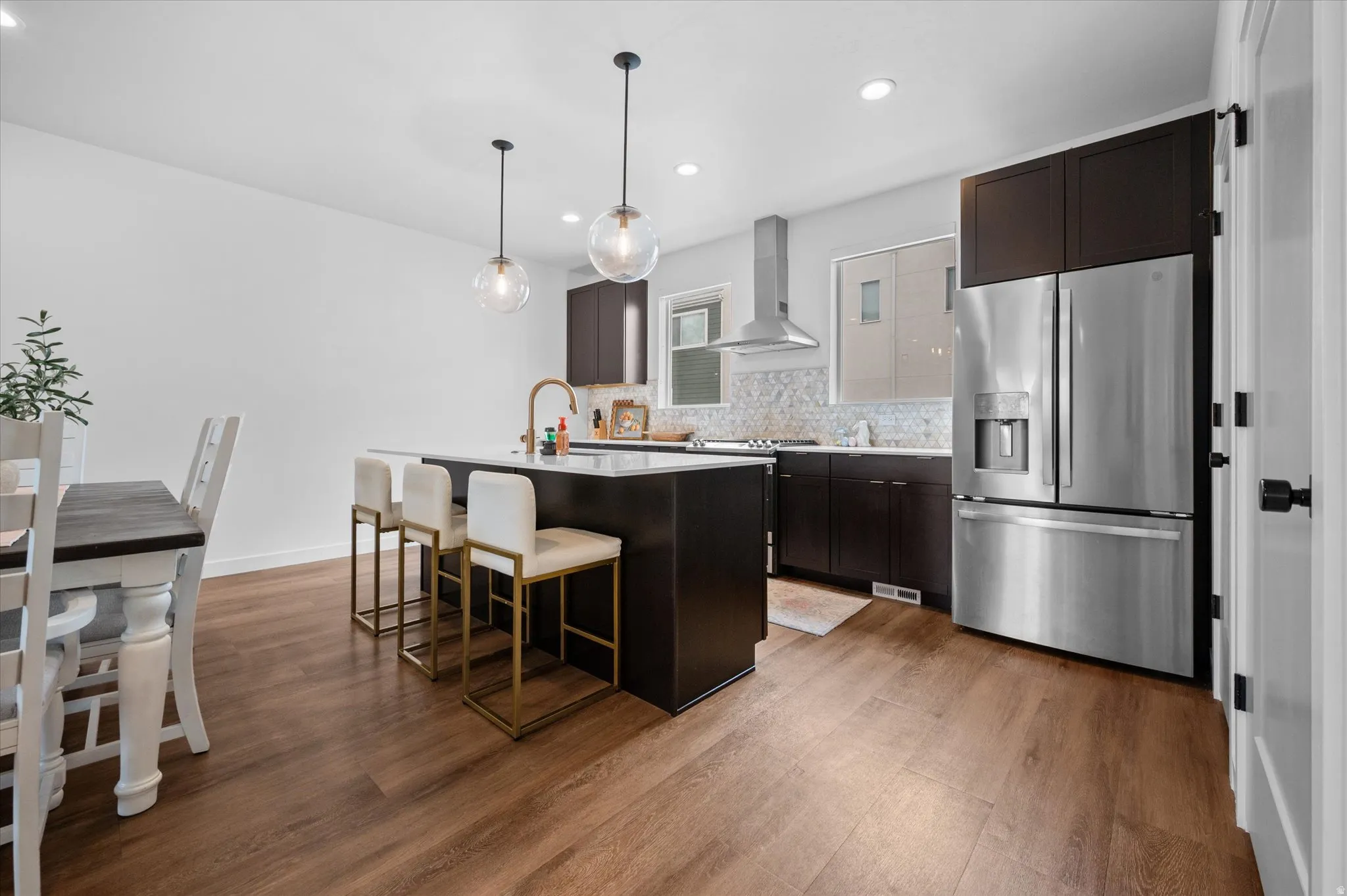 Spacious kitchen featuring state of the art appliances, quartz countertops, and decorative pendant lighting.