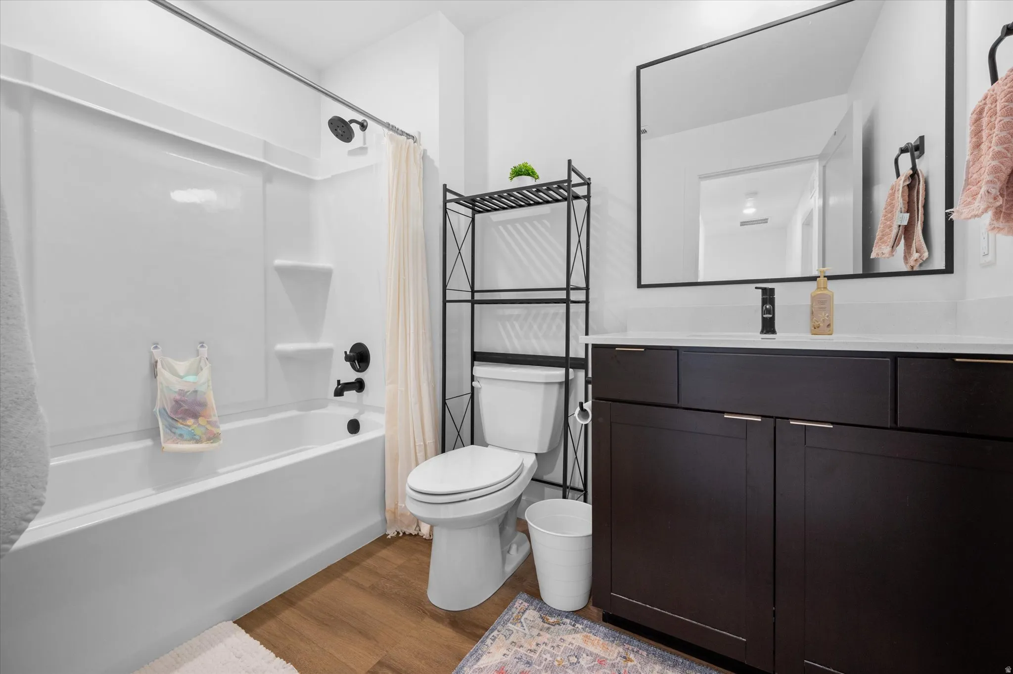 Full upstairs bathroom with solid wood cabinetry, quartz countertop, and LVP flooring.
