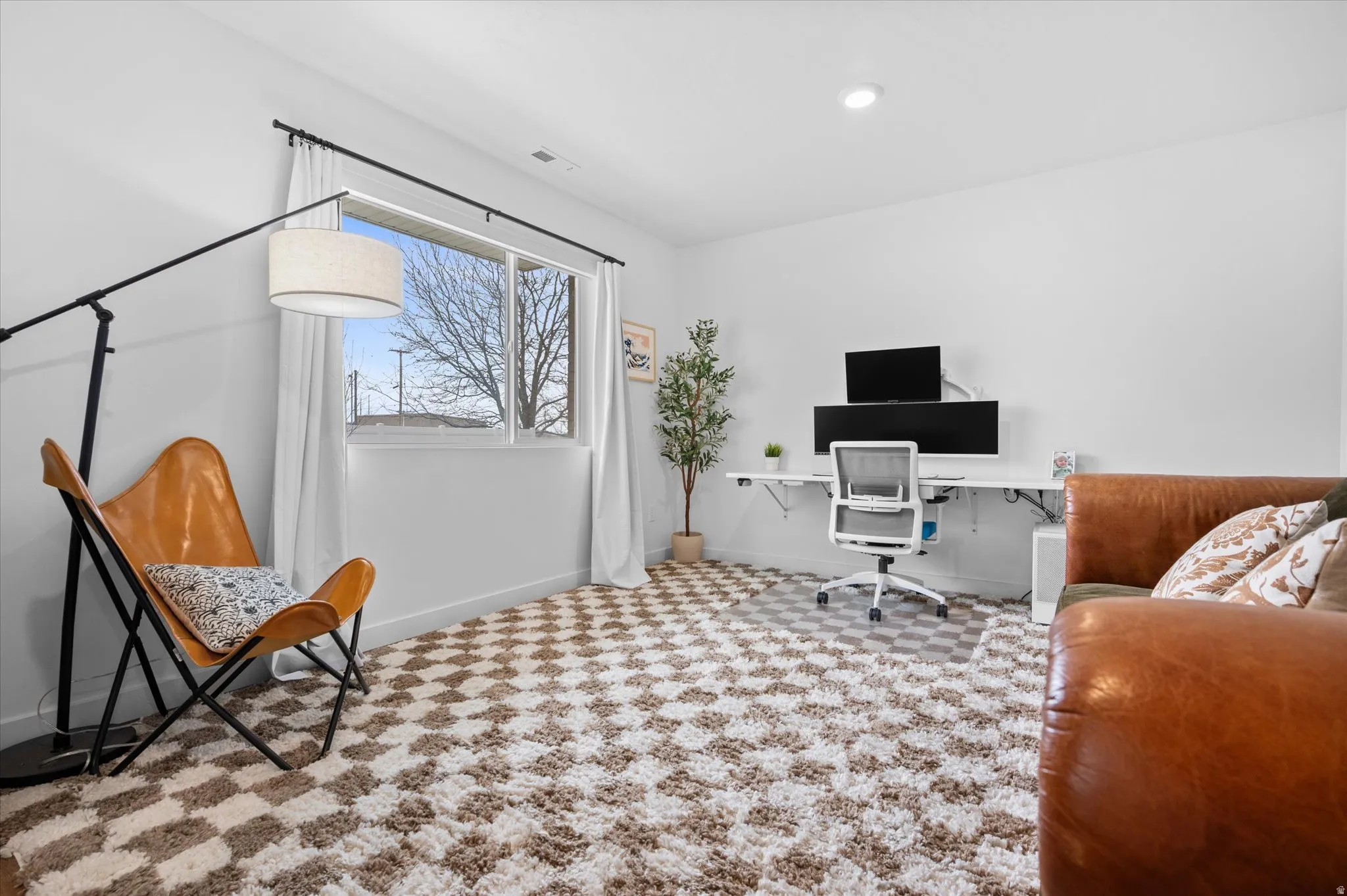 Office space/Living Room with LVP flooring, large decorative rug, and vinyl window for natural southern light.