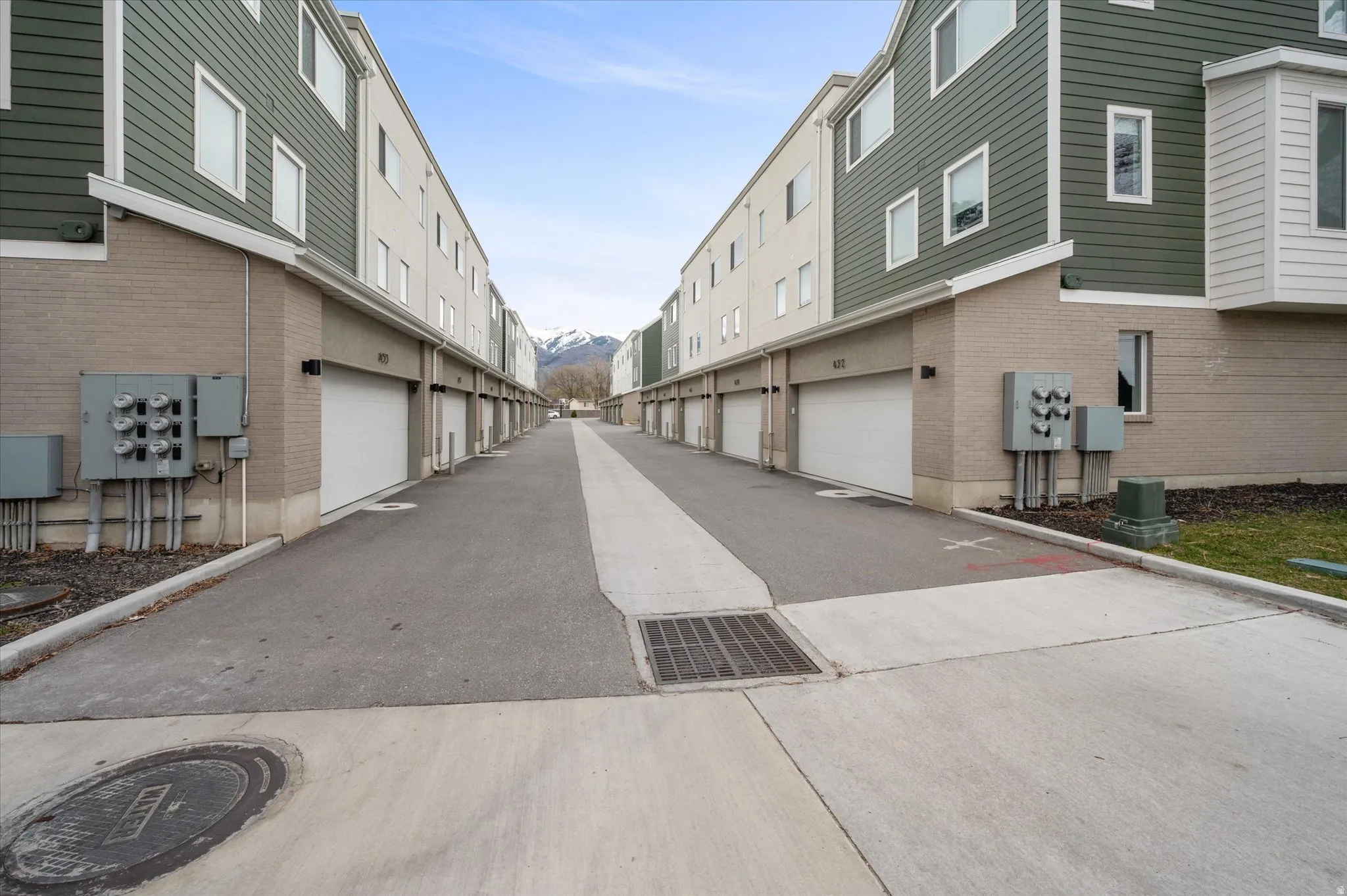 View of asphalt entry to garages.