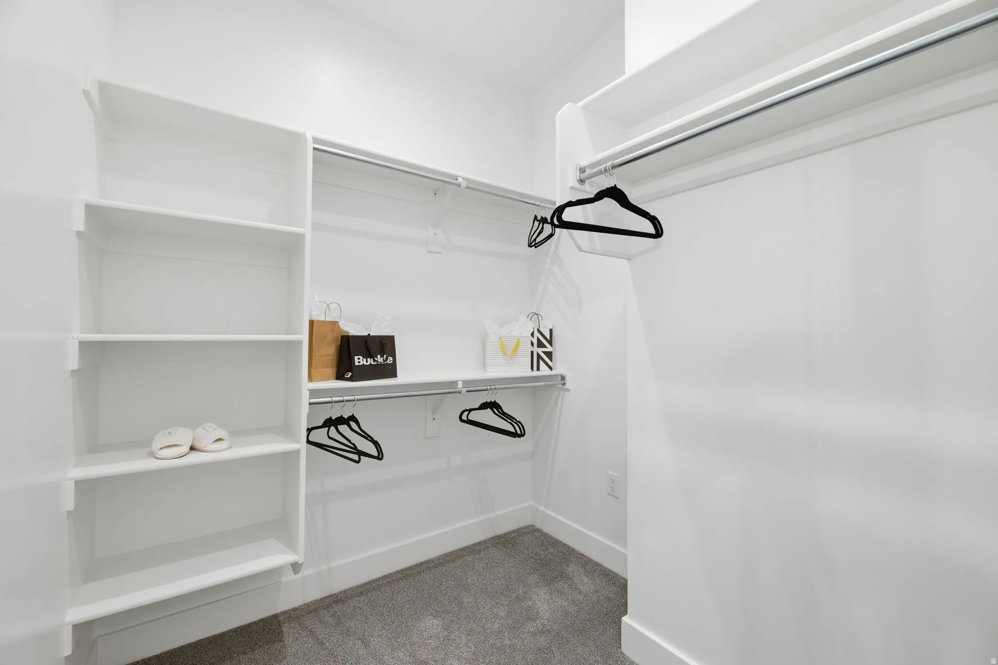 Walk in closet with dark carpet