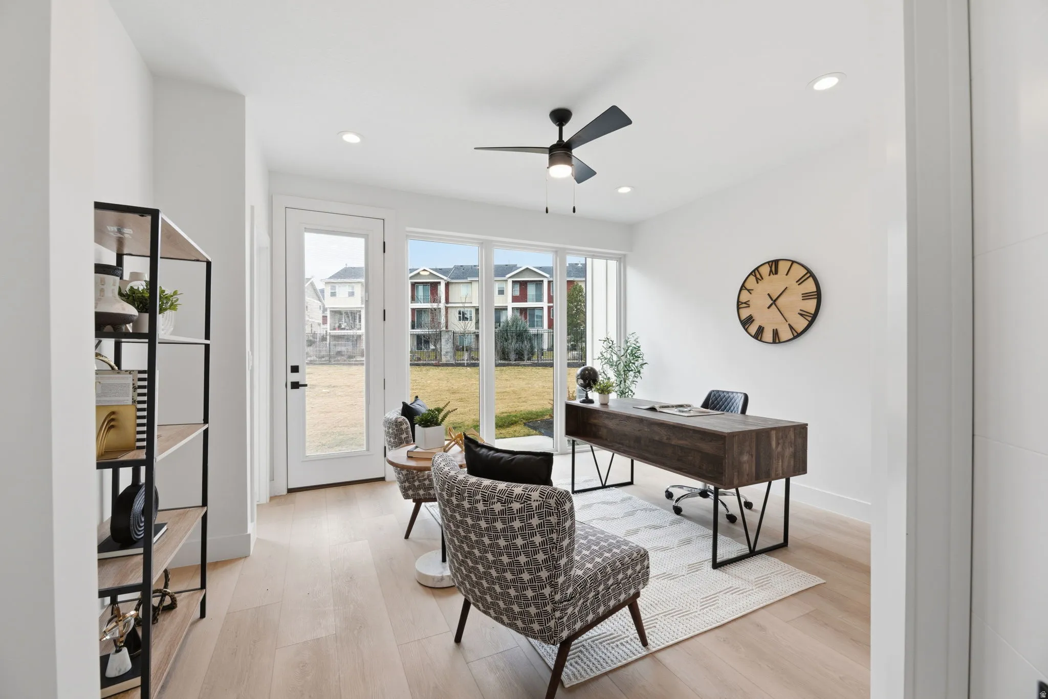 Office space featuring light wood finished floors, a ceiling fan, and recessed lighting
