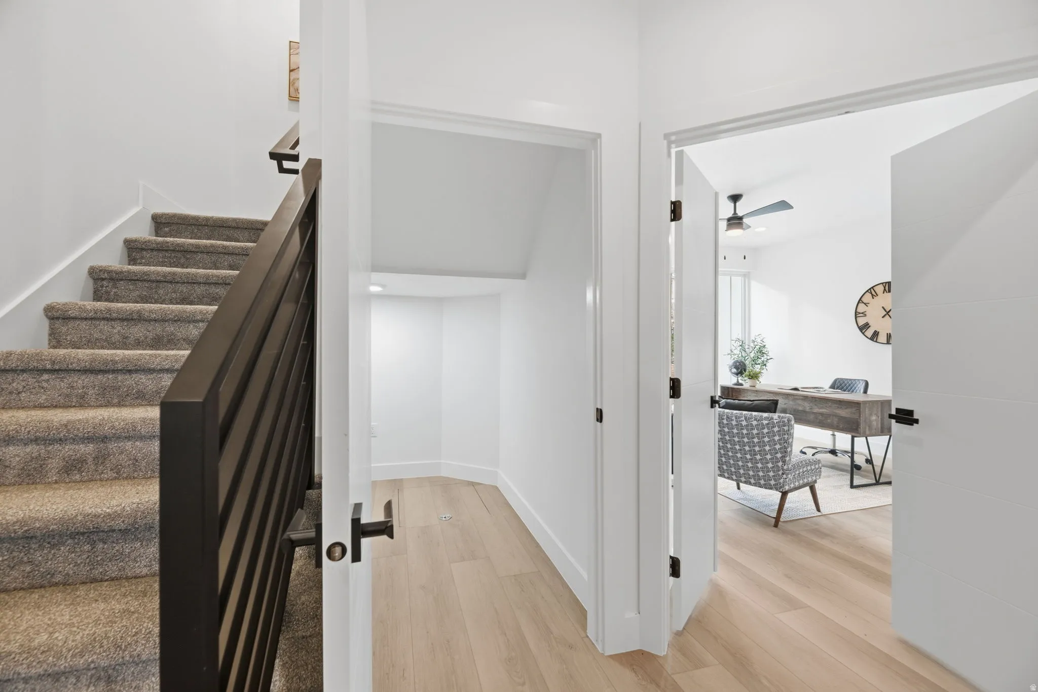 Staircase featuring wood finished floors and ceiling fan