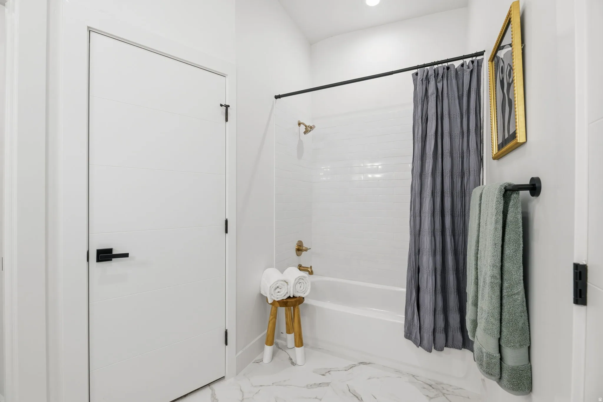 Full bath featuring shower / tub combo, recessed lighting, and light marble finish flooring