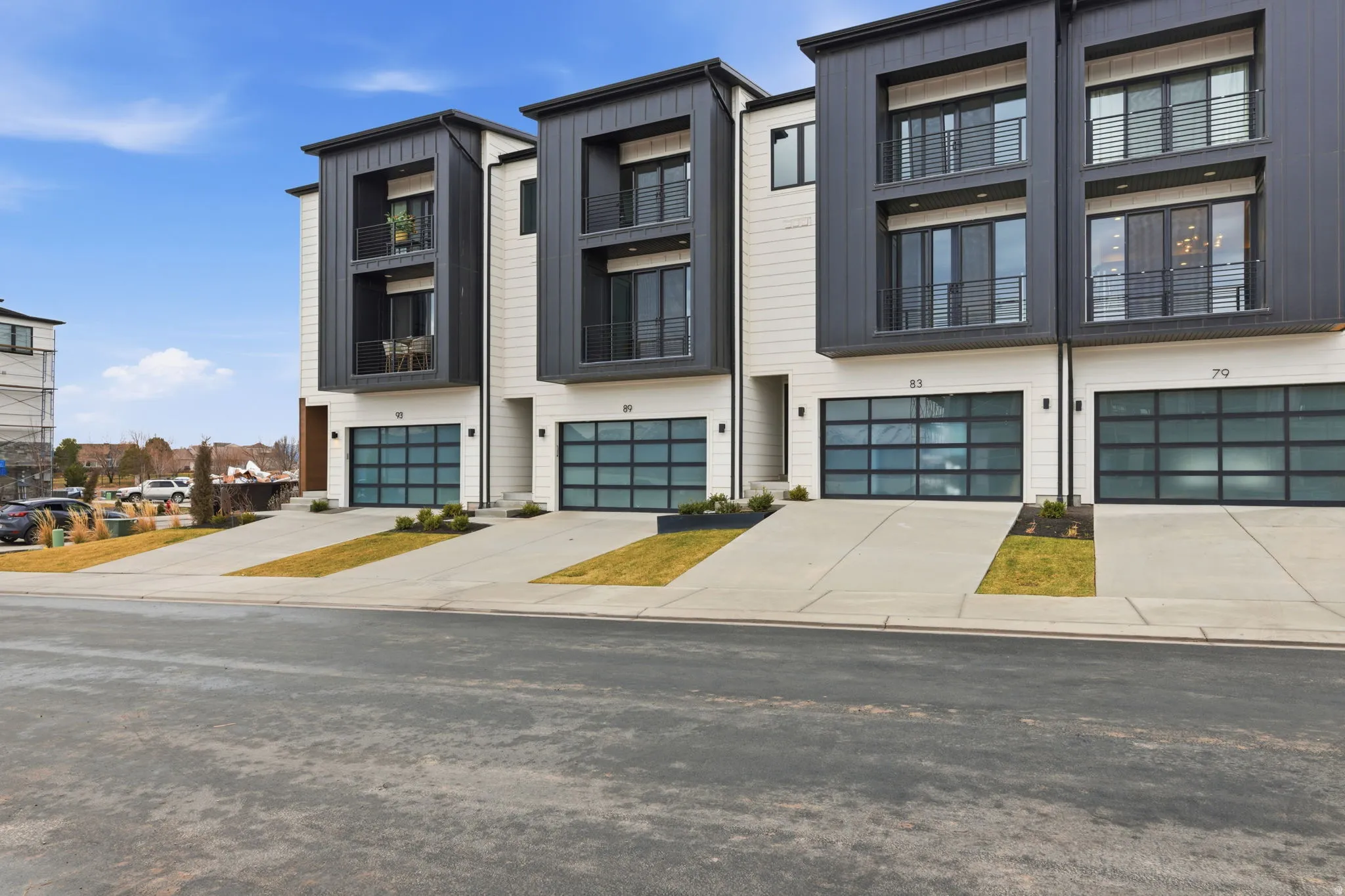 View of front of house featuring a garage, concrete driveway, and board and batten siding