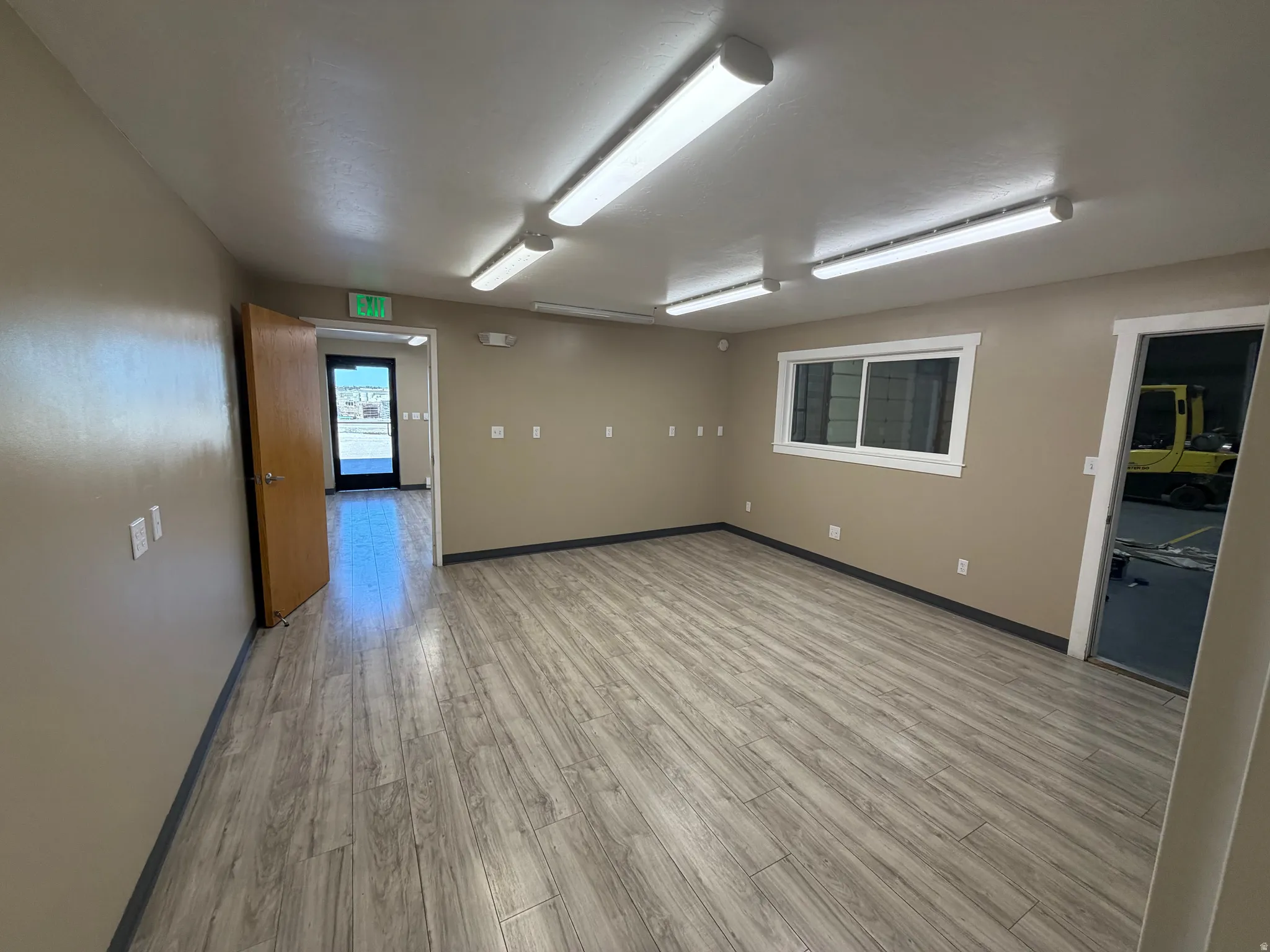 Unfurnished room featuring light wood-style floors and baseboards