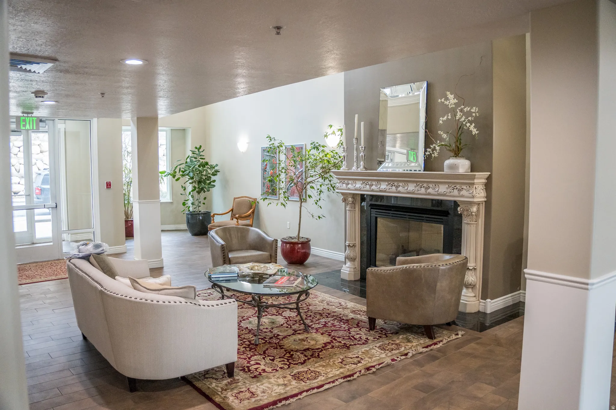 Living room featuring wood finished floors, a premium fireplace, and recessed lighting