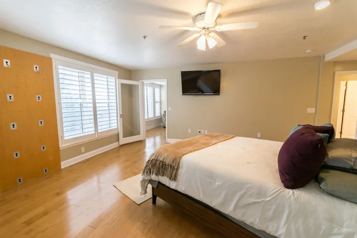 Bedroom with light wood-type flooring and a ceiling fan