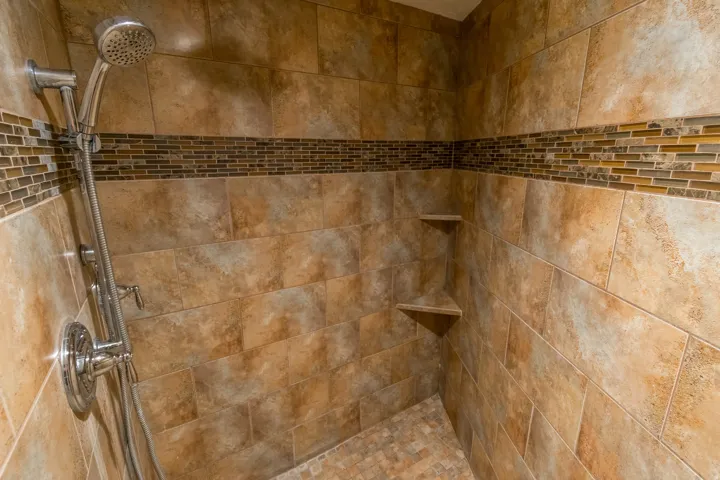 Bathroom view of a tile shower