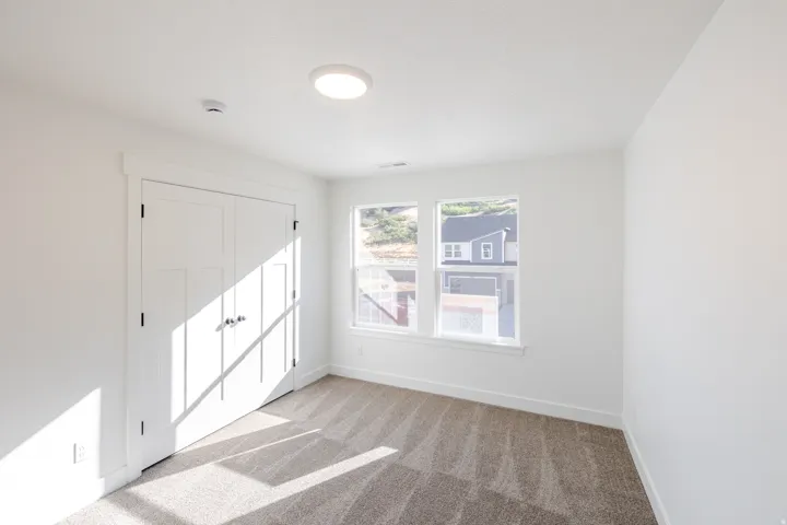 White painted walls with a neutral carpet flooring