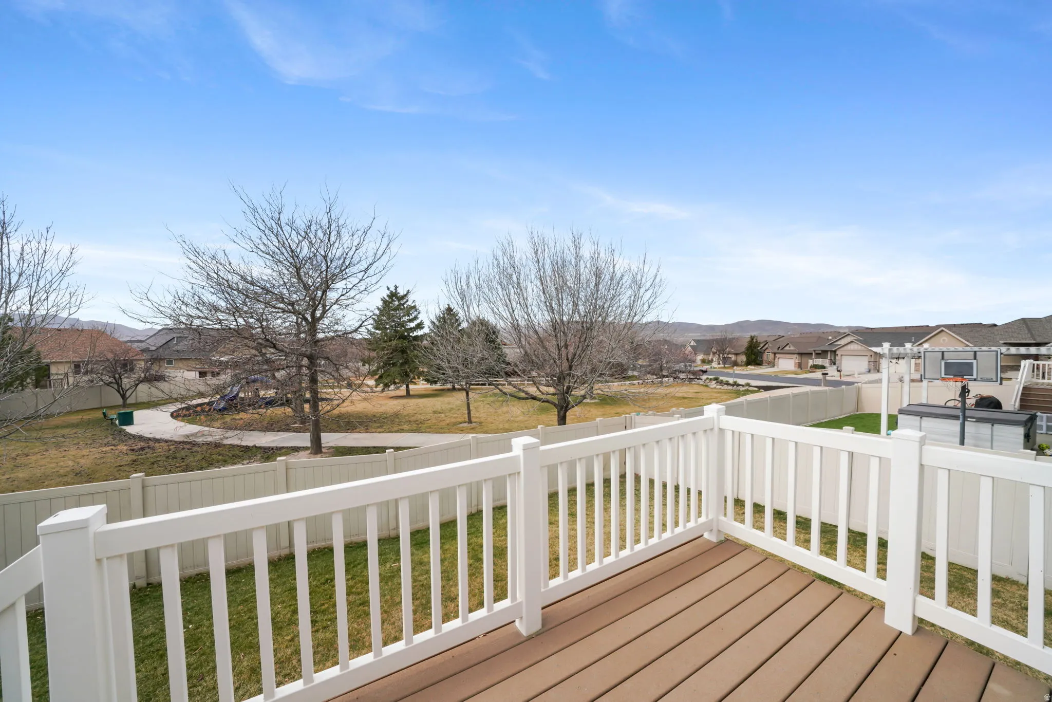 Wooden terrace featuring a residential view and a fenced backyard