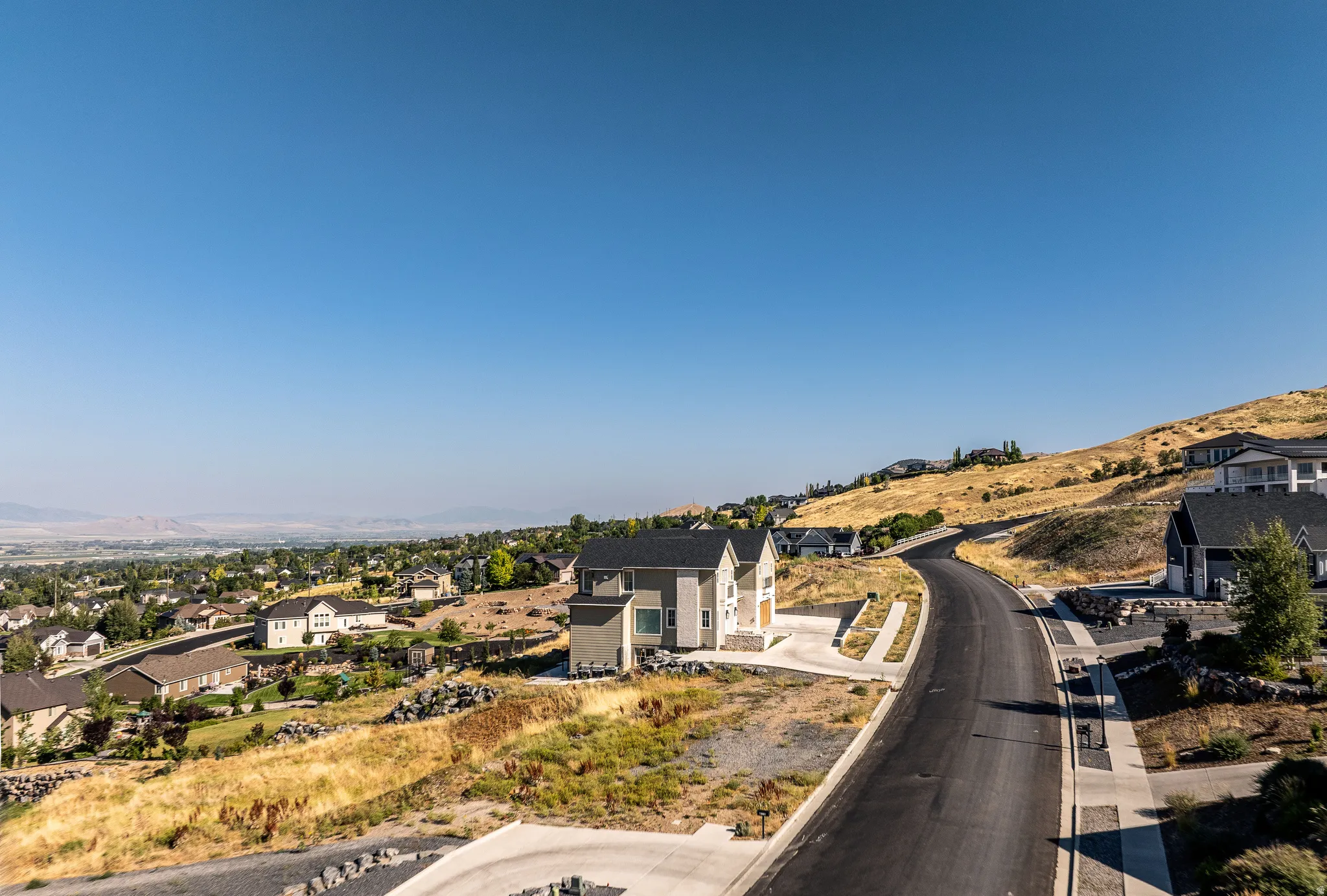 View of asphalt street featuring a residential view and a mountain view