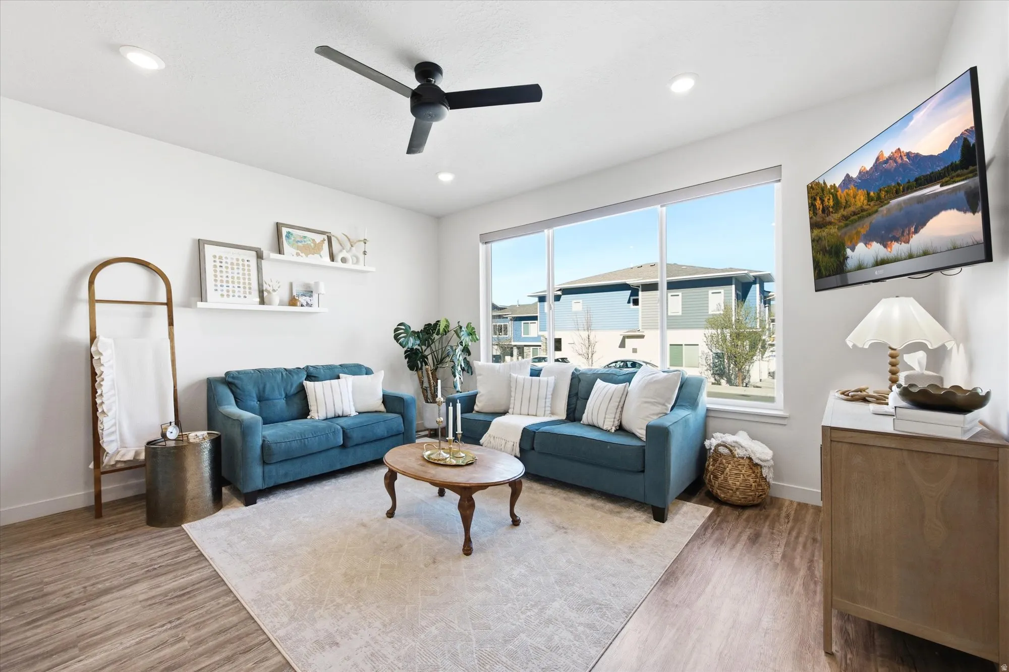 Living room featuring a ceiling fan, wood finished floors, and recessed lighting