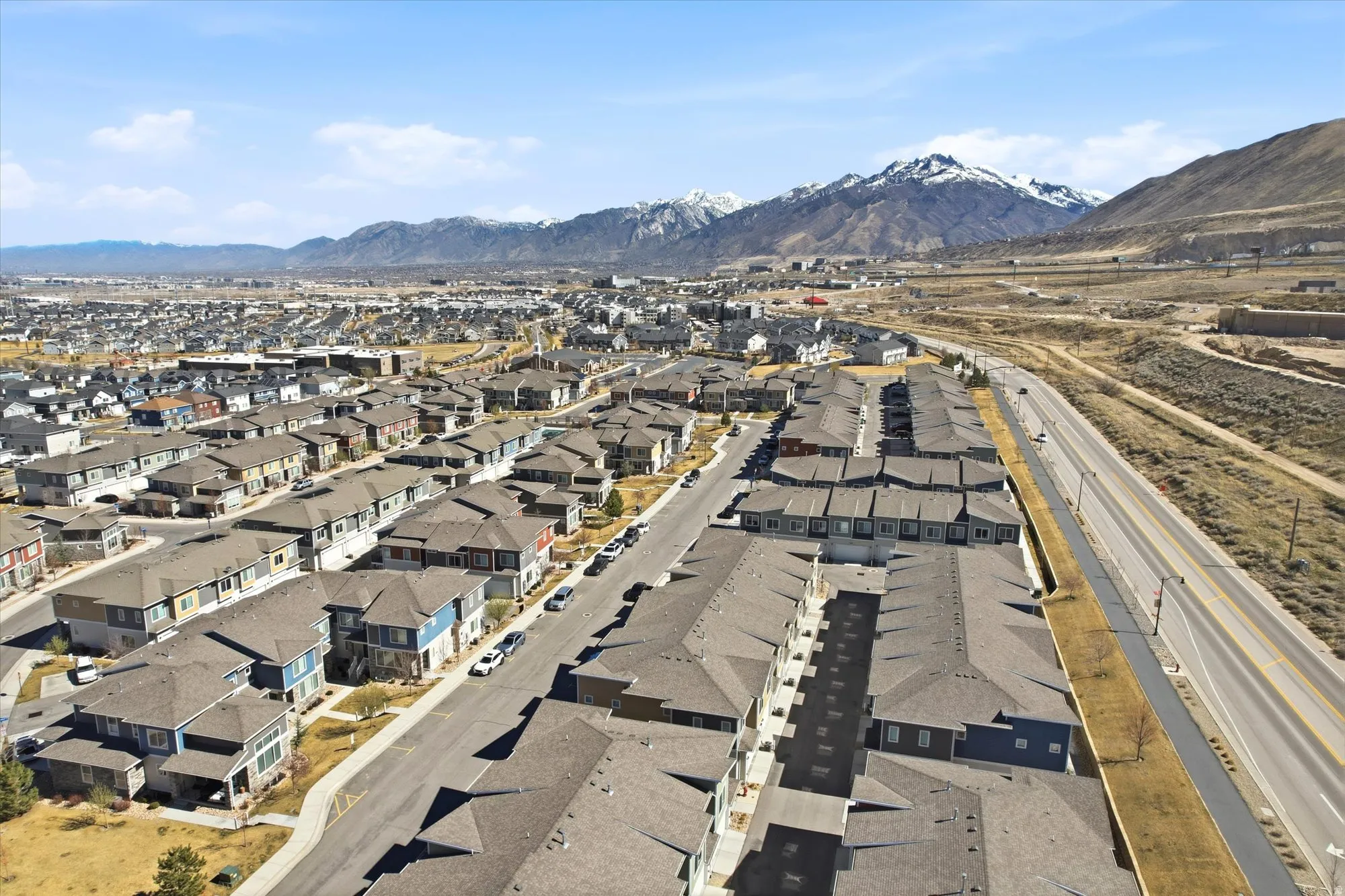 Aerial overview of property's location featuring a mountainous background and nearby suburban area