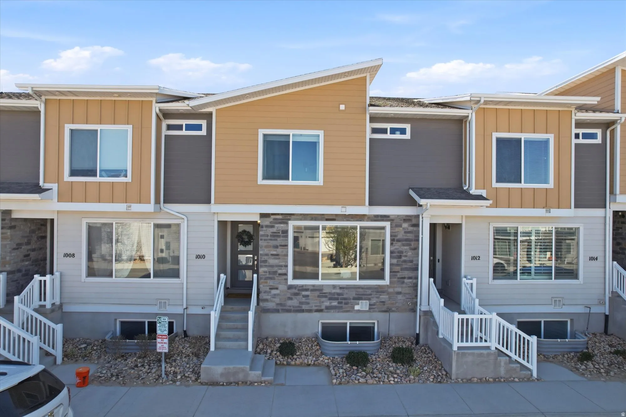 View of front of house featuring board and batten siding and stone siding