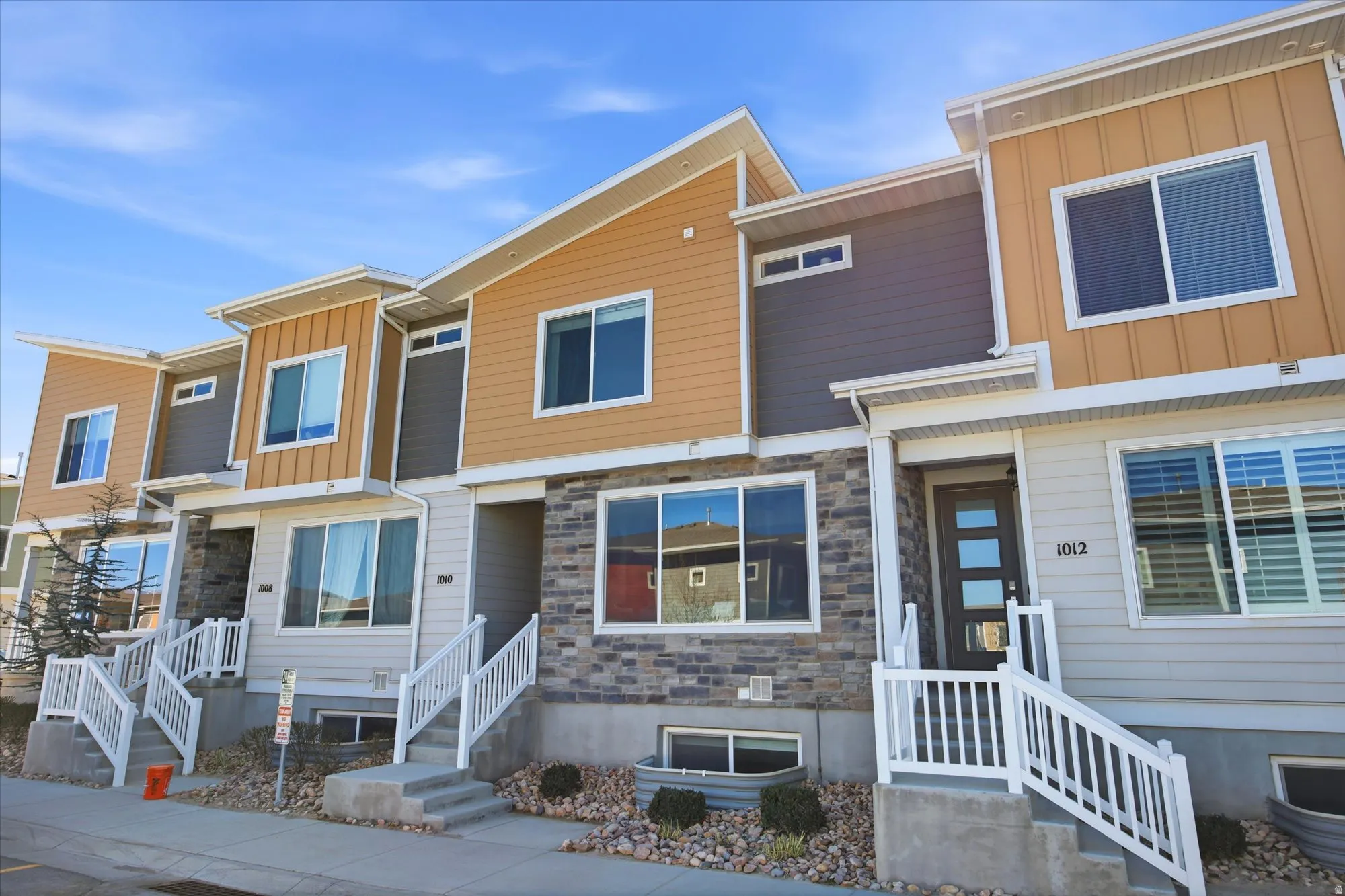 Contemporary house with board and batten siding and stone siding