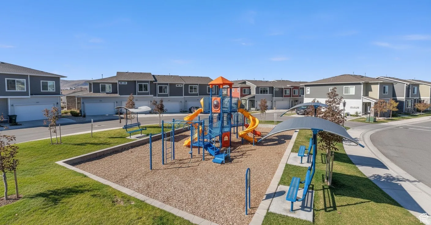 Community playground with a residential view and a yard