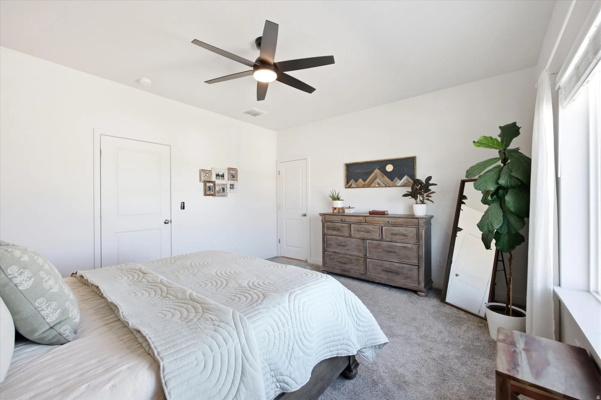 Bedroom with carpet floors and a ceiling fan