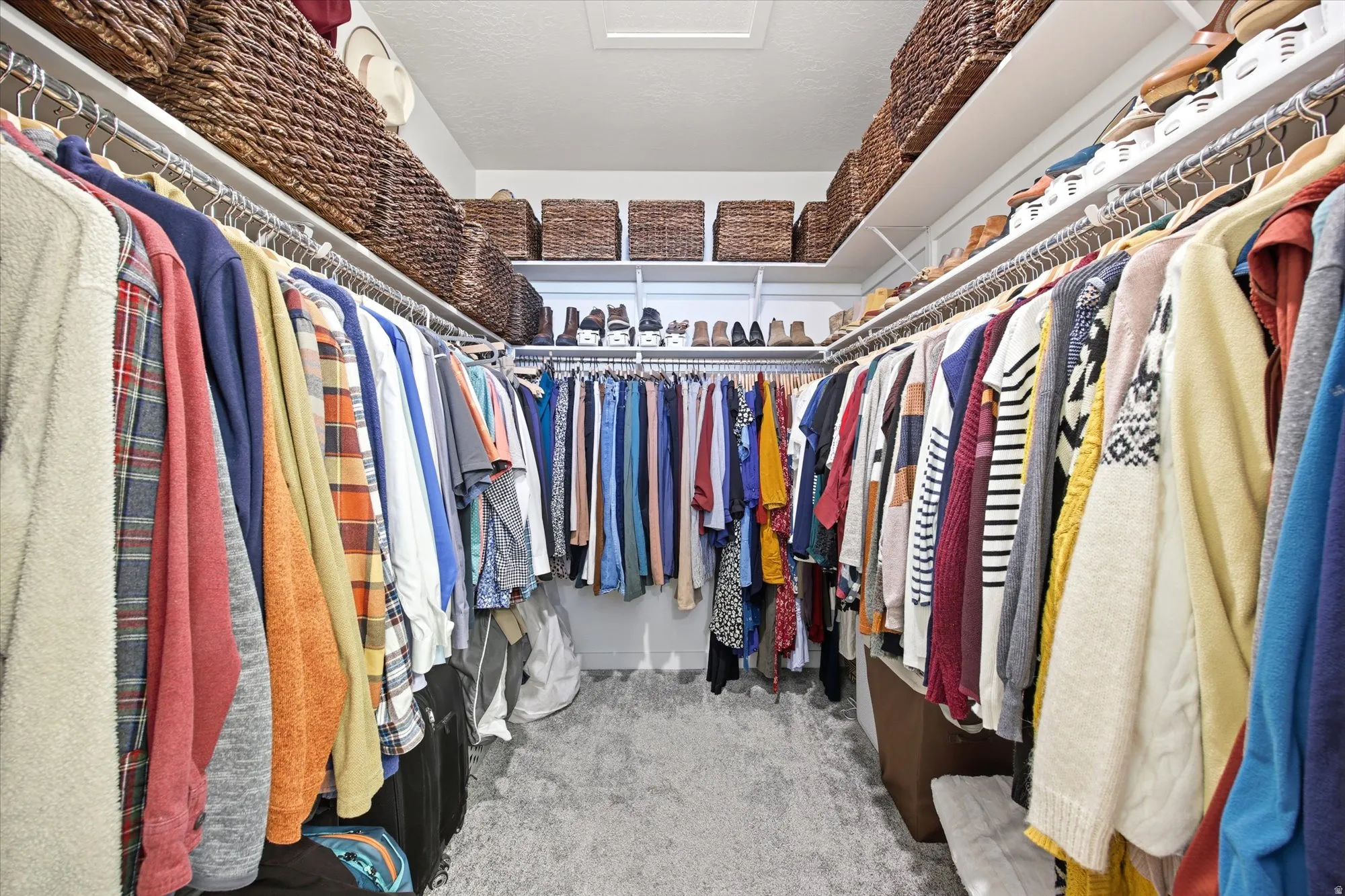 Walk in closet featuring light carpet