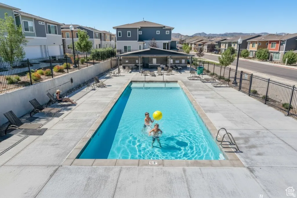 Community pool with a residential view and a patio
