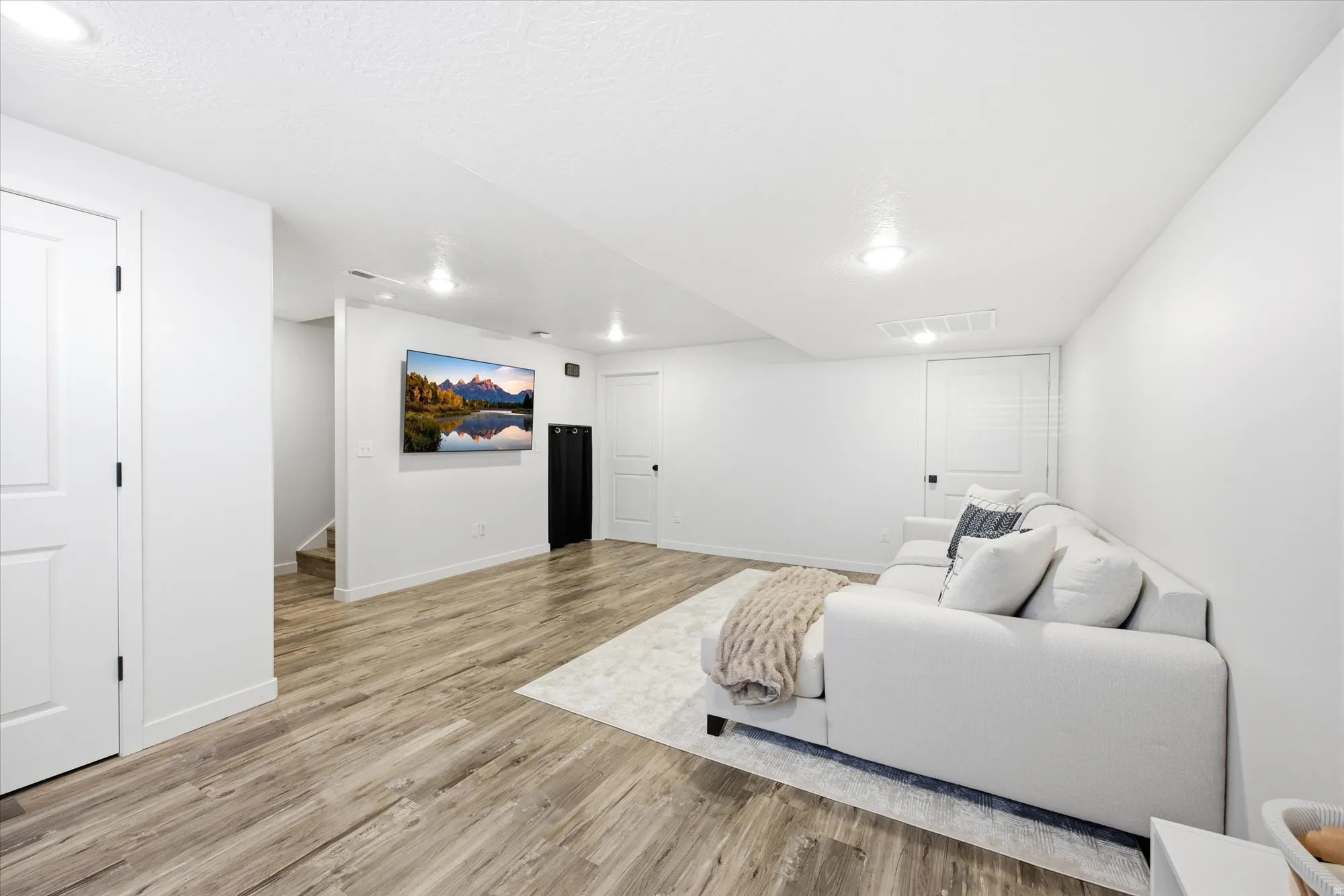Living area with light wood-type flooring and baseboards