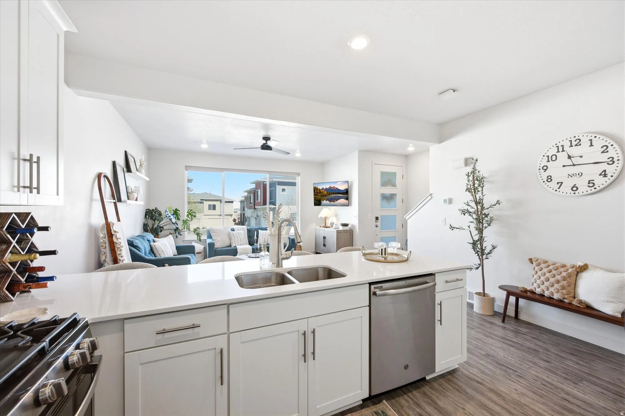 Kitchen with open floor plan, a peninsula, white cabinets, stainless steel appliances, and recessed lighting
