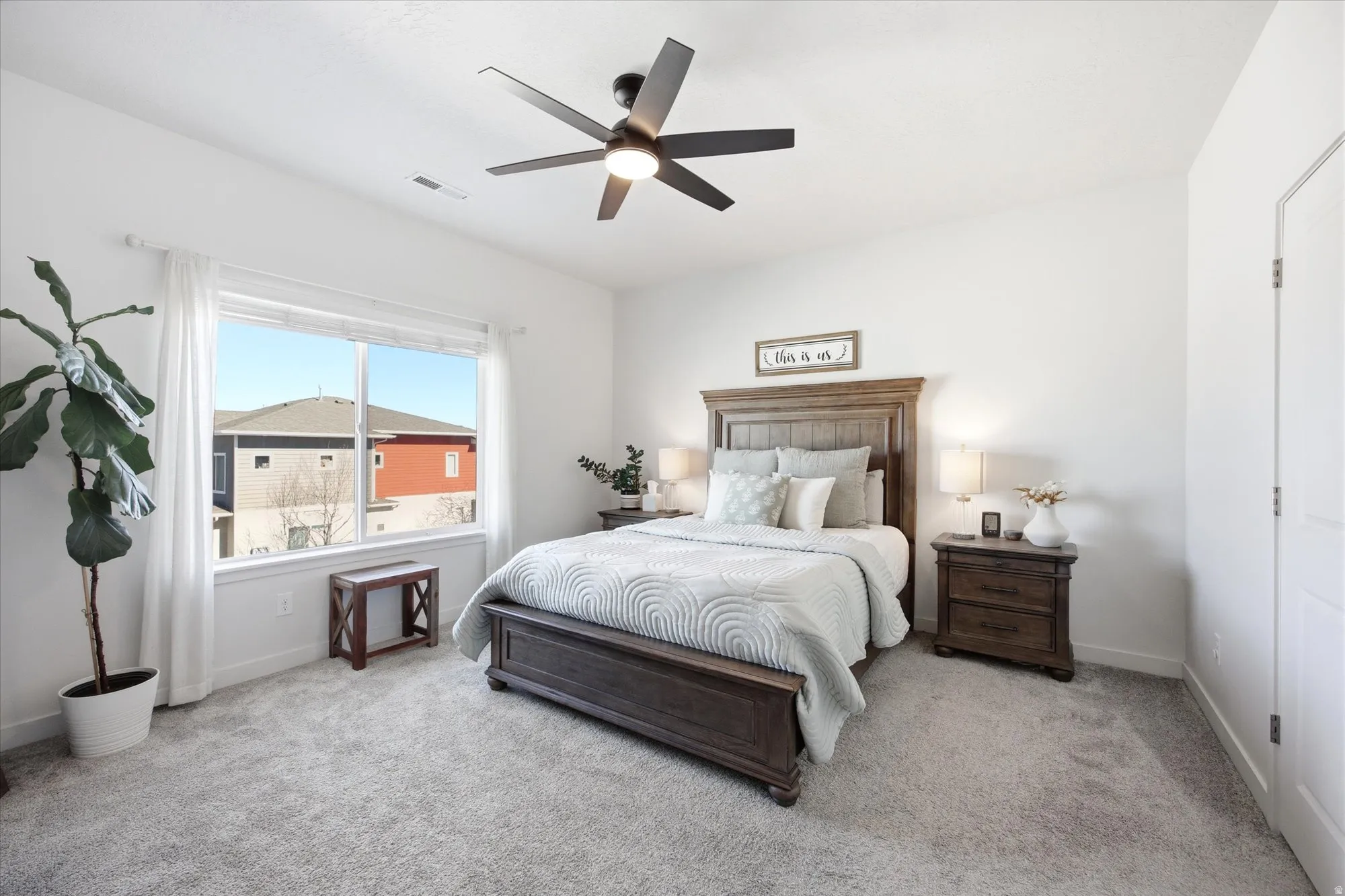 Carpeted bedroom featuring baseboards and a ceiling fan