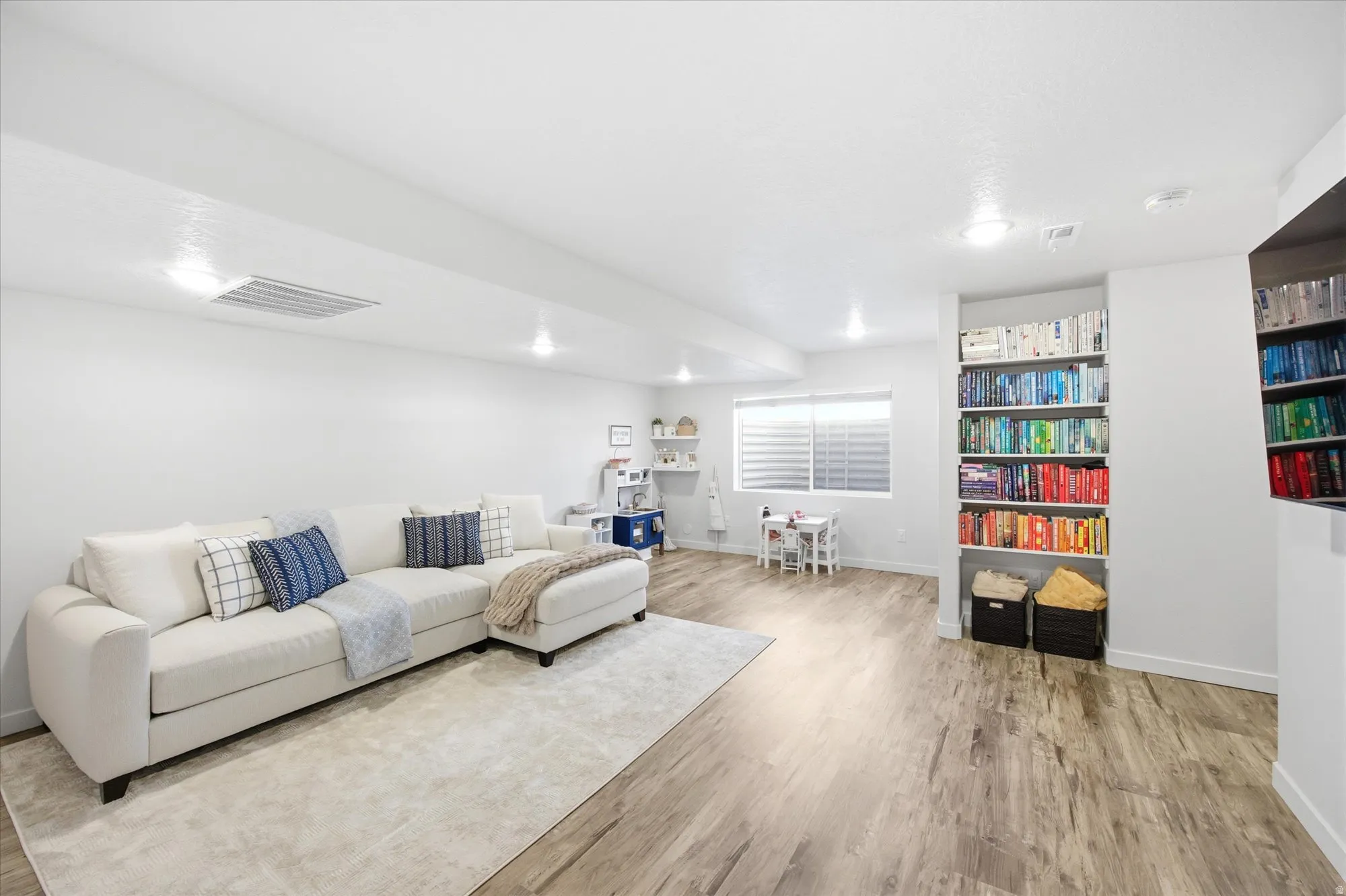 Living room with baseboards and light wood-type flooring