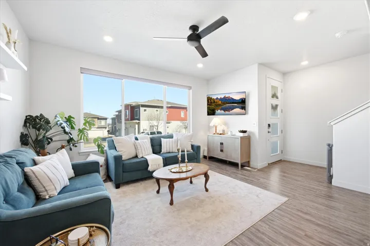 Living area featuring a ceiling fan, wood finished floors, and recessed lighting
