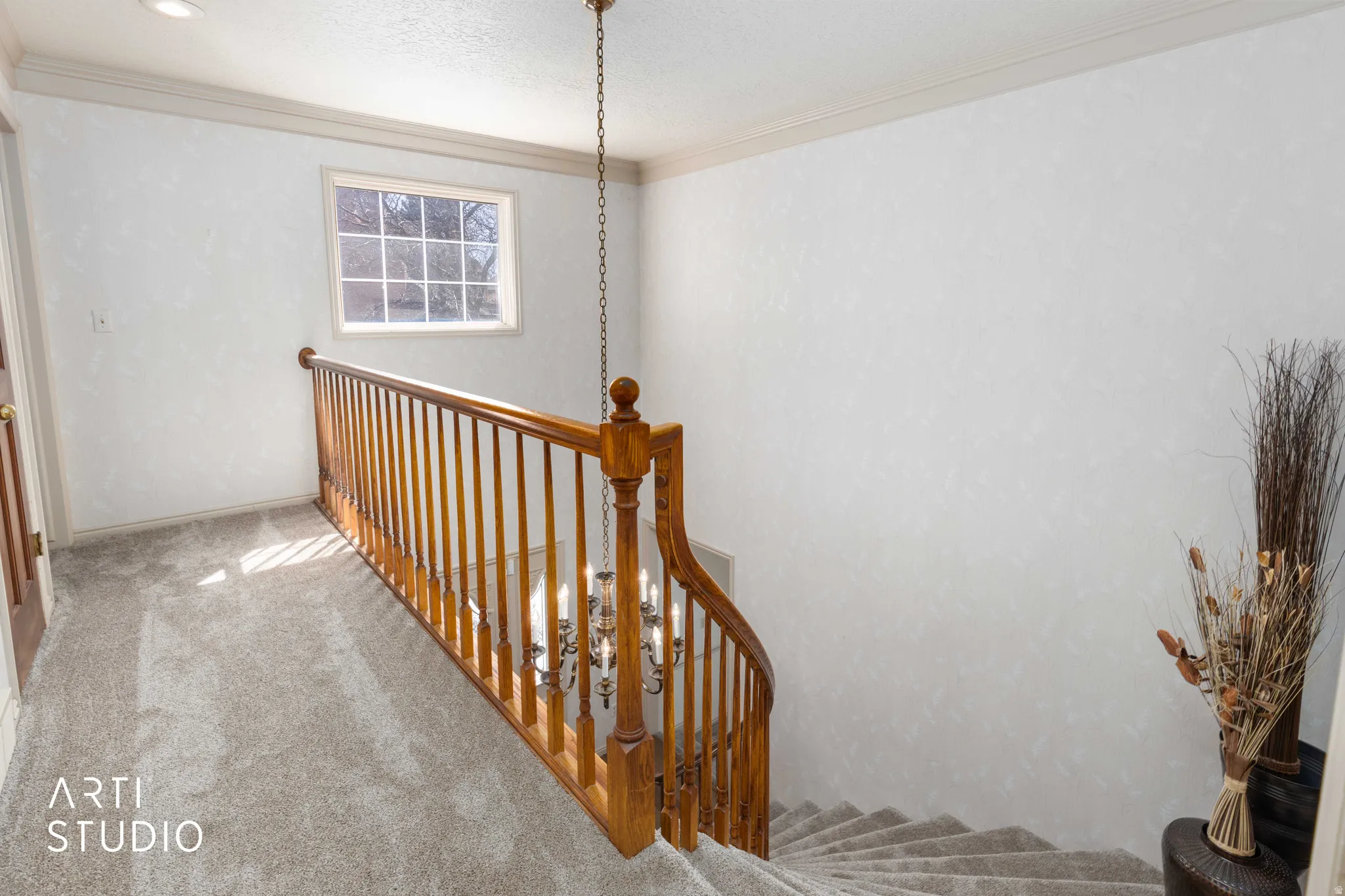 Stairs with carpet flooring and ornamental molding