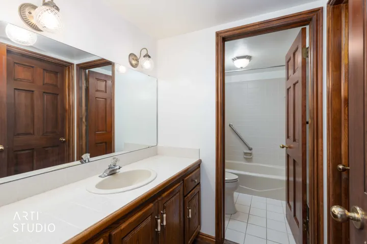 Bathroom featuring vanity, light tile patterned flooring, and shower / bathtub combination
