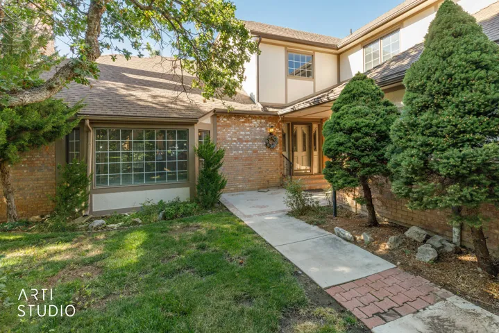 Brick and stucco exterior with a multi-pane bay window