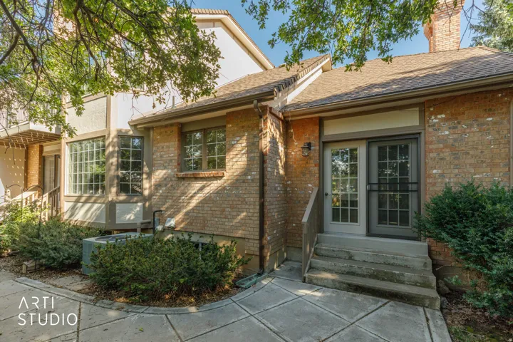 Brick exterior facade, dual-pane windows, glass block window feature, and patio with concrete pavers