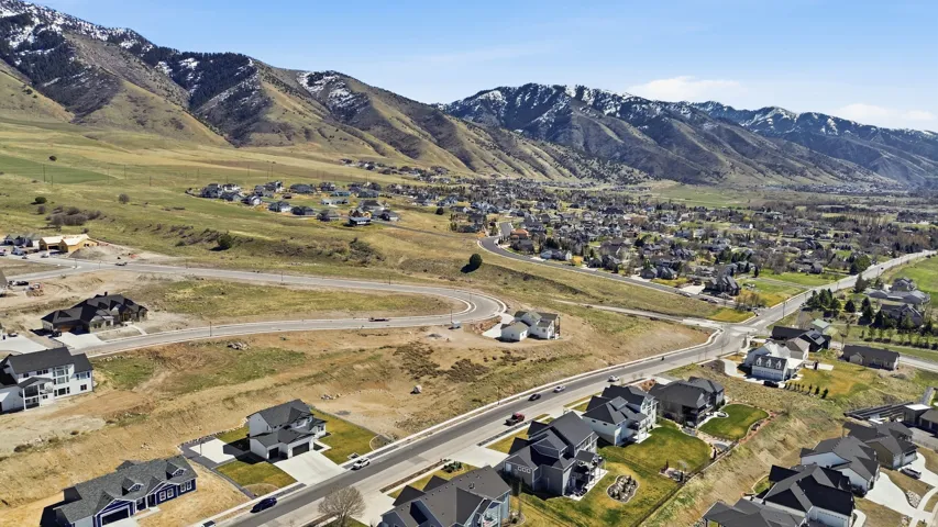 Aerial overview of property's location featuring nearby suburban area and a mountainous background