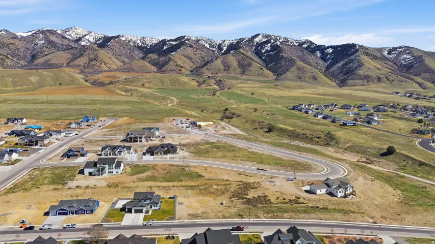 Aerial view of property's location with nearby suburban area and mountains