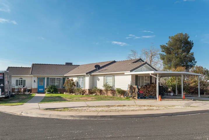 Ranch-style house with a tiled roof and brick siding