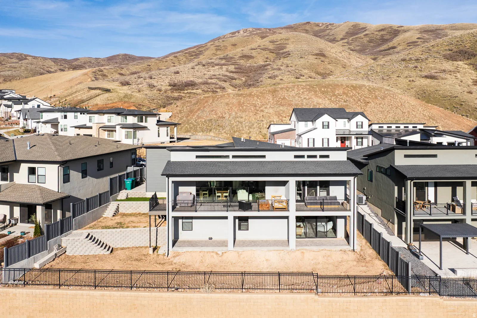 Back of property featuring a residential view, a fenced backyard, a patio area, and a mountain view