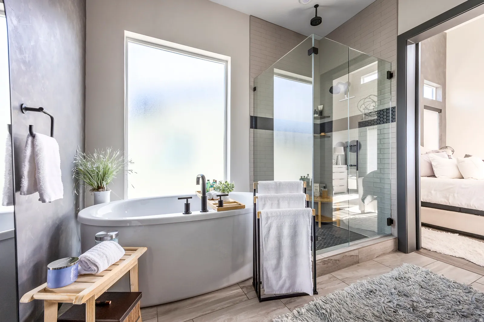 Bathroom with ensuite bathroom, a shower stall, and a freestanding tub