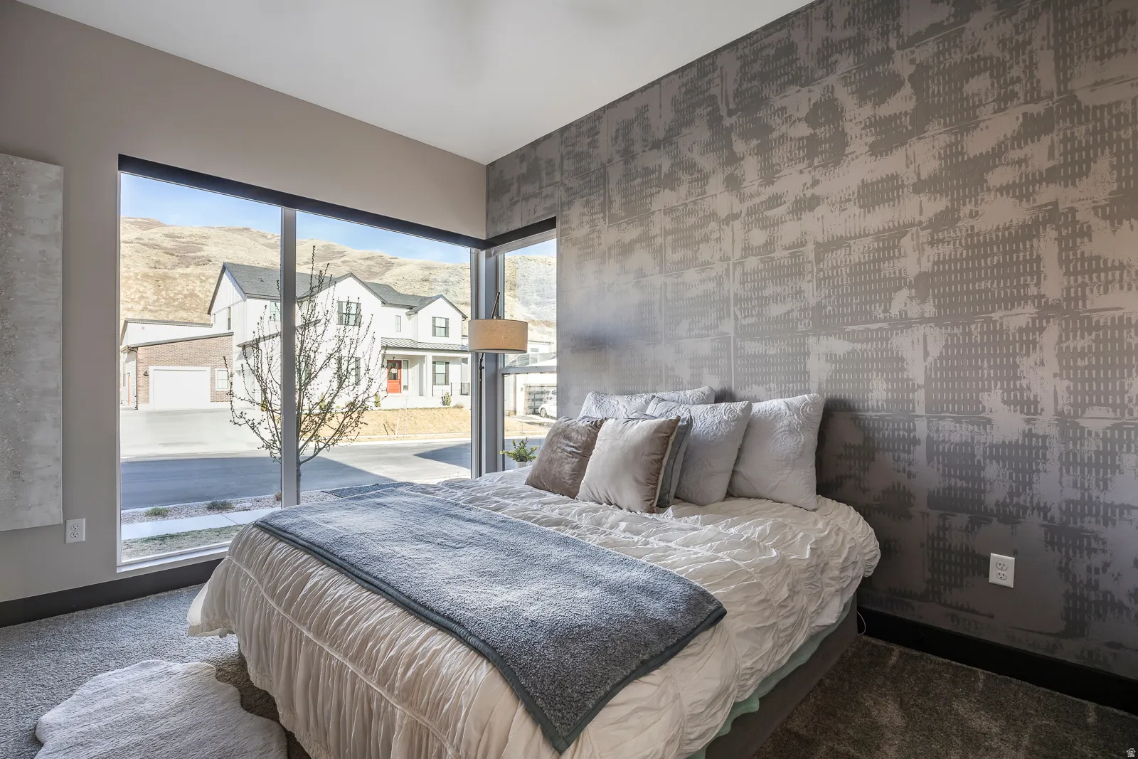 Bedroom with wallpapered walls and carpet flooring