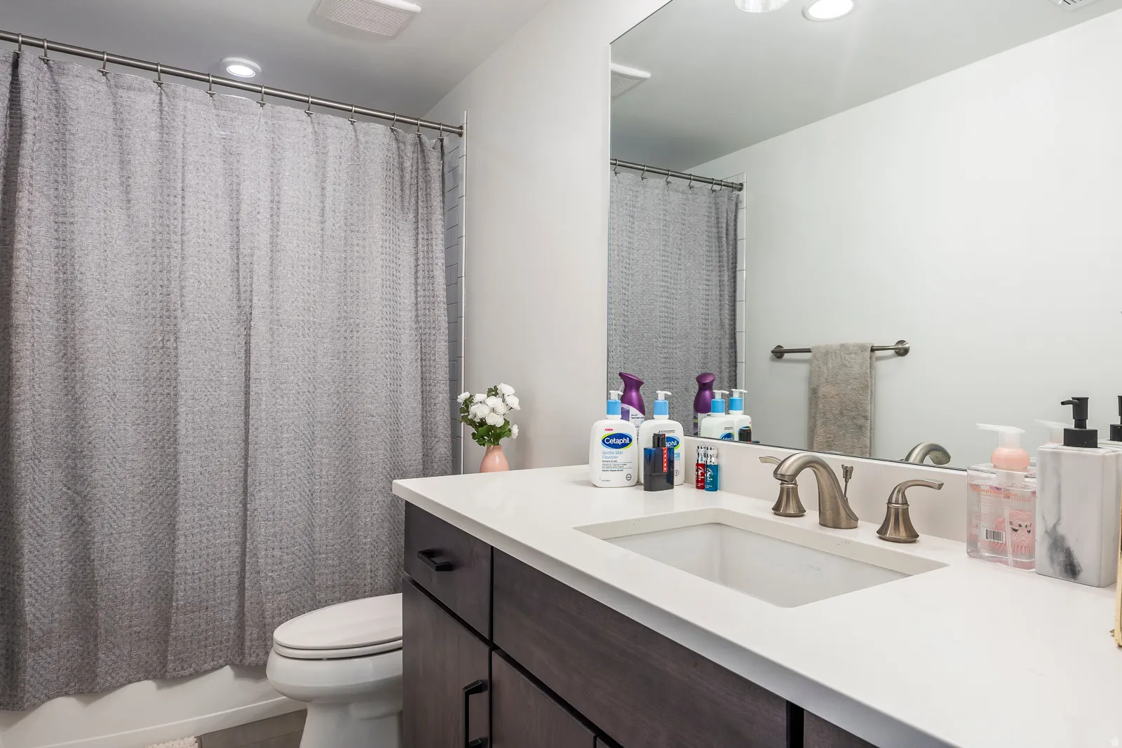 Full bathroom featuring vanity and a shower with shower curtain