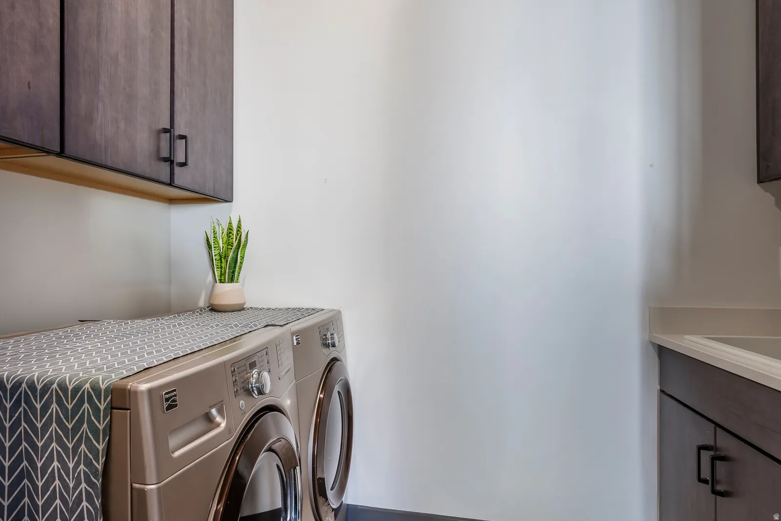 Laundry area with cabinet space and washing machine and dryer