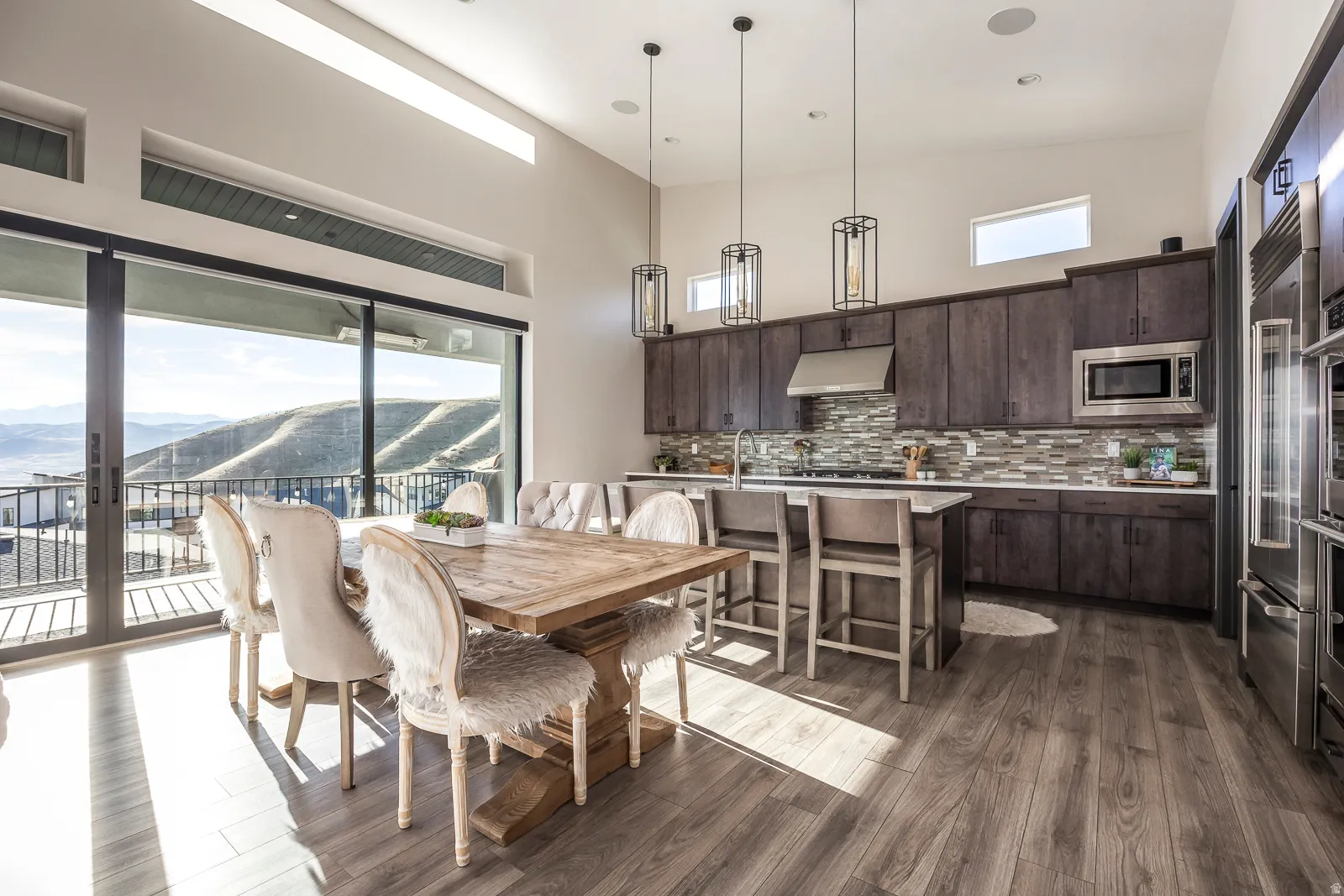 Dining room with a mountain view, a high ceiling, and dark wood finished floors