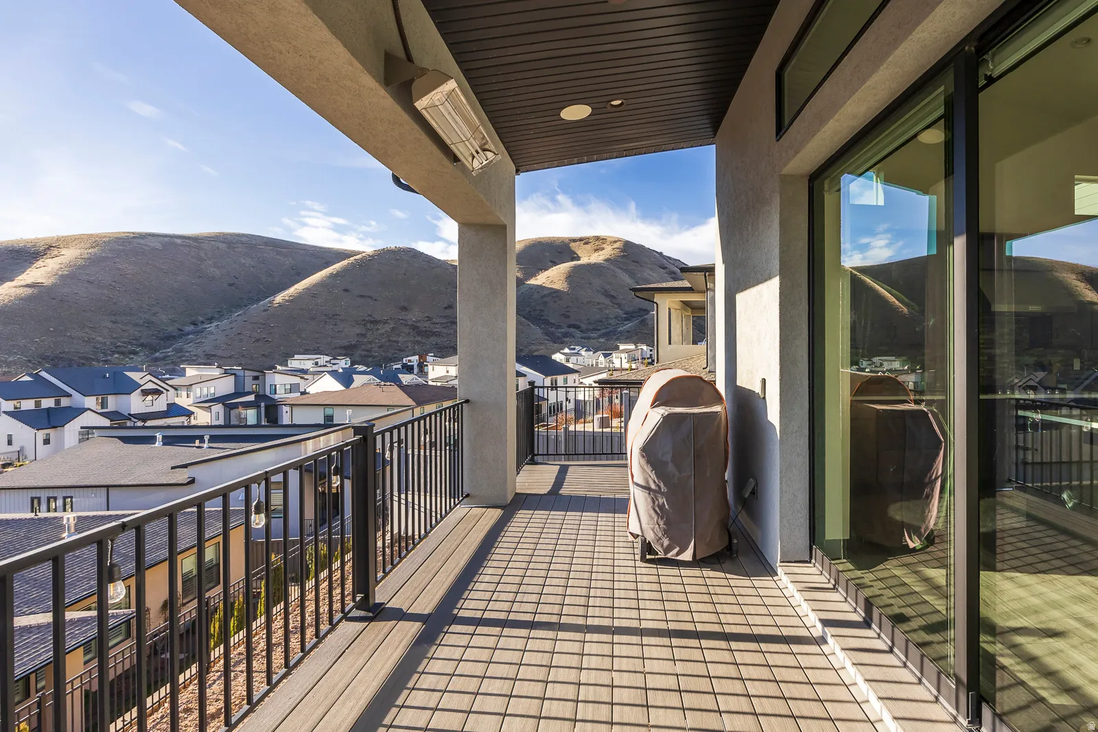Balcony with a mountain view, a grill, and a residential view